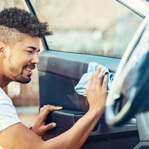 man cleaning car