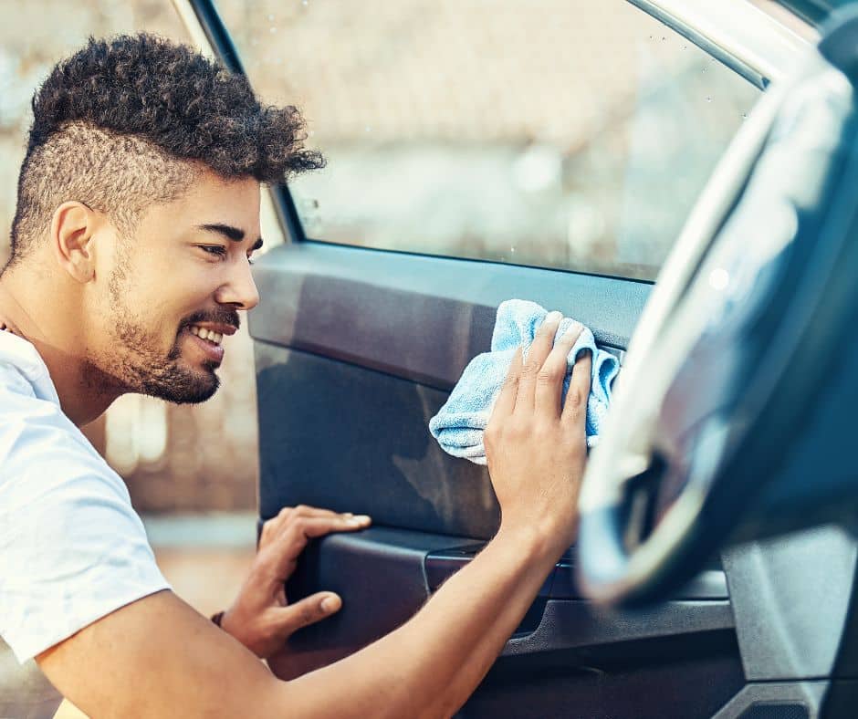 man cleaning car