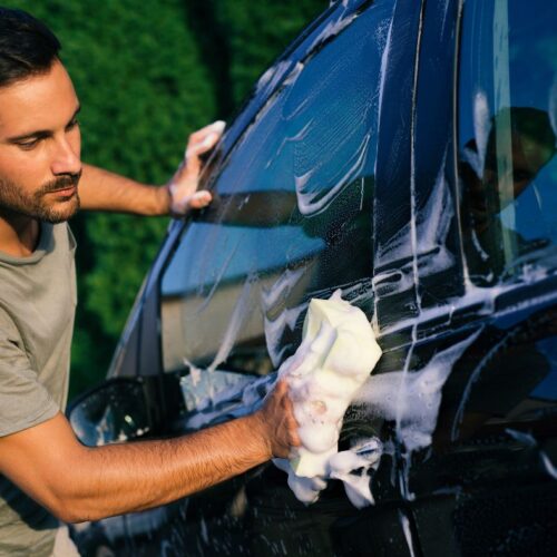 man washing car